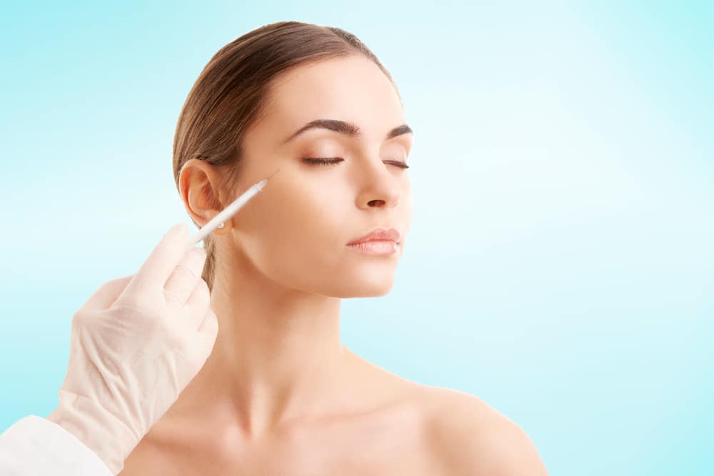 Woman receiving a BOTOX® injection around her eyes for crow’s feet.