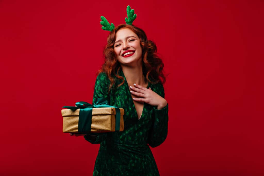 Woman with glowing skin from facial treatments dressed up and ready for holiday parties.